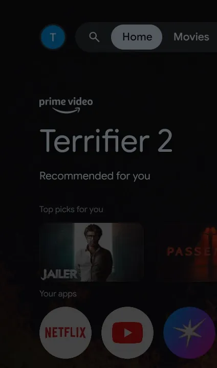 The stock Google TV home: a Prime Video ad for Terrifier 2, Top picks for you, and an app row, dimmed behind a system dialog